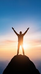 Fototapeta premium Silhouette of a person celebrating on a mountain peak at sunrise, arms raised against a colorful sky.