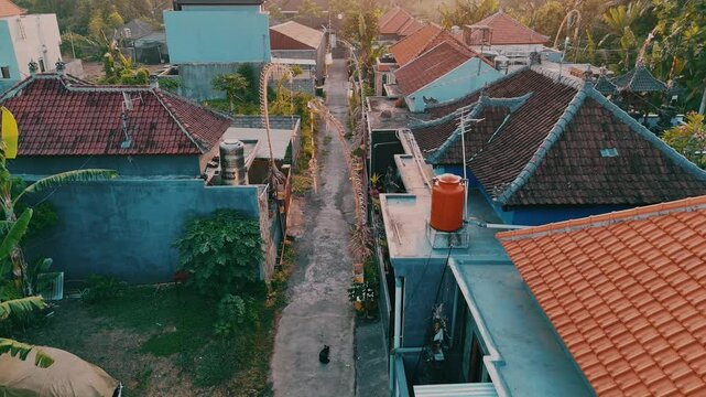 Aerial footage of traditional Balinese symbols and decorations, positioned at the entrance of each house. Drone moves flawlessly through Penjors. 4K