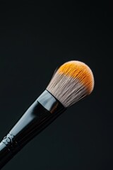 Fototapeta premium A close-up image of a makeup brush highlighting its soft, textured bristles against a dark background, emphasizing beauty and cosmetic artistry.