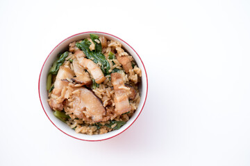 a bowl of Chinese Mustard Green Rice on white background. This bowl of mustard green rice consists of pork belly, dried prawns and mustard greens