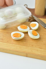 cut two pieces of omega boiled eggs served on a wooden cutting board