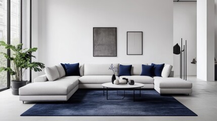 A minimalist living room with crisp white walls, a light gray sectional sofa, and navy blue accent pillows