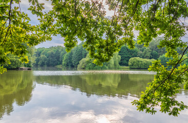 Summer landscape with beautiful lake, green trees and blue sky