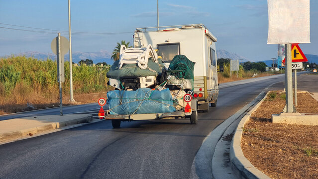caravan car on the road travelling carrying thigs on trailer