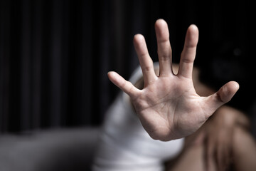 Obraz premium Close up of woman showing stop gesture with hand blurred background. Stop violence against women. Intimidation and abuse of women. Physical and psychological harassment.