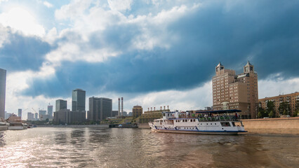 Fototapeta premium Cruise ship sails on the Moscow river in Moscow city center, popular place for walking.