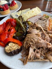 Buffet BBQ lunch combination of meat, vegetables and cheese on the white plate