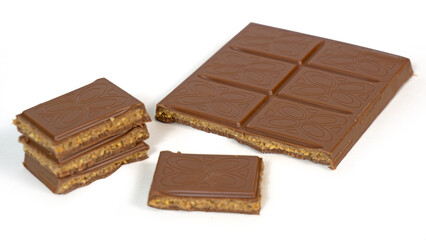 Milk chocolate bar filled with cookie dough caramel butter nuts filling with pieces stacked isolated on white background