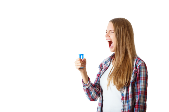 Woman in plaid shirt yelling with a blue megaphone, isolated on a white background. Concept of communication and expression