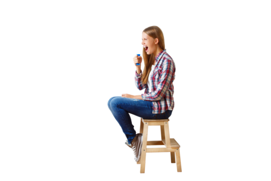 Woman in casual clothes sitting on stool holding a megaphone, isolated on white background. Concept of communication and announcement
