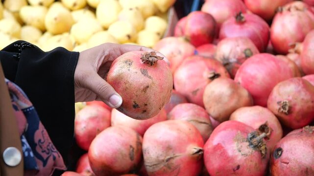 Fresh and Juicy Pomegranates Surrounded by a Variety of Quality Produce at the Market