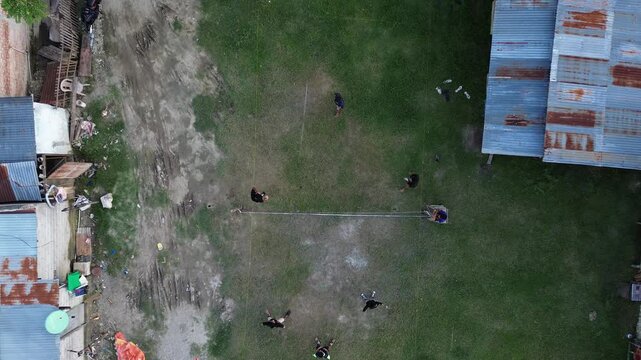 Aerial view of group of young men are playing takraw in the afternoon
