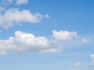 Obraz premium A serene blue sky filled with fluffy white clouds, creating a peaceful and calming aesthetic, tranquil, calming, serene