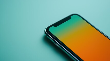 A close-up of a smartphone on a teal background, featuring gradient display that transitions from orange to green.
