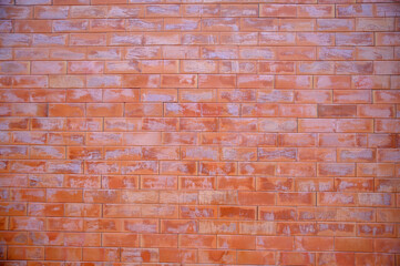 Weathered brick wall texture with intricate patterns of red brick and aged mortar