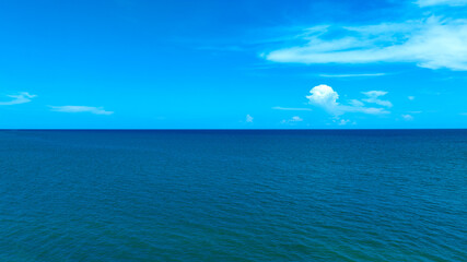 Nature of the beach and sea Summer with sunshine, sandy beaches, clear blue waters sparkling against the blue sky. On an island with good ecology and environment Background for summer vacation concept
