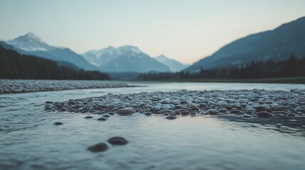 Riverbed Stones in Front of Blurry Mountain Range at Dusk