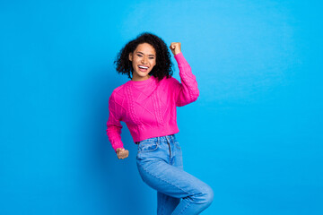 Portrait of pretty young lady raise fists luck wear pink pullover isolated on blue color background