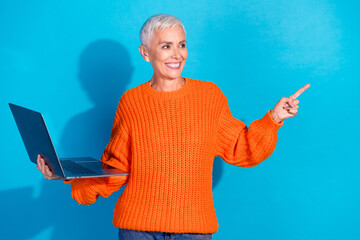 Photo of old lady positive hold use netbook indicate finger empty space ads isolated blue color...