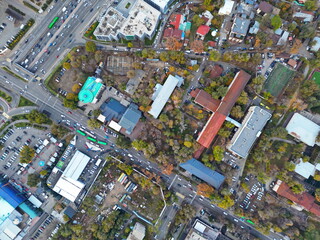 View of the city, with different buildings and streets. Sunset time. Autumn. The view from the drone.