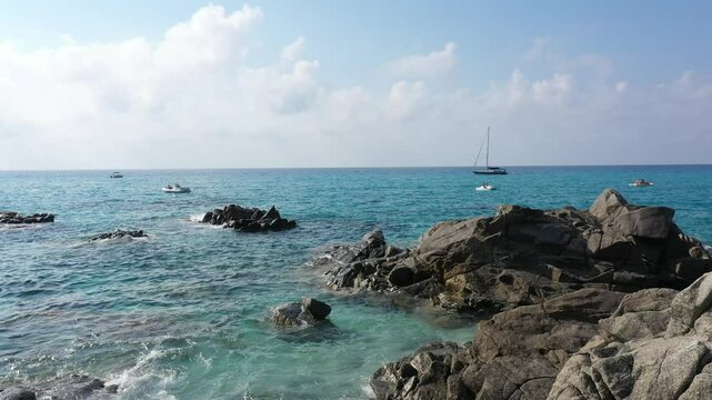 Aerial view of sea and rocky beach in Marinella Di Zambrone on a sunny summer day in Calabria, Italy