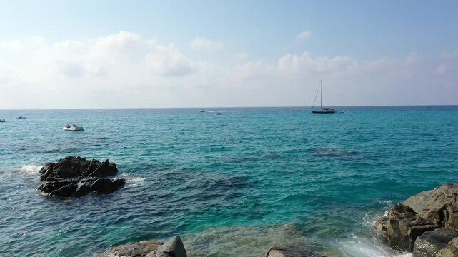 Aerial view of sea and rocky beach in Marinella Di Zambrone on a sunny summer day in Calabria, Italy