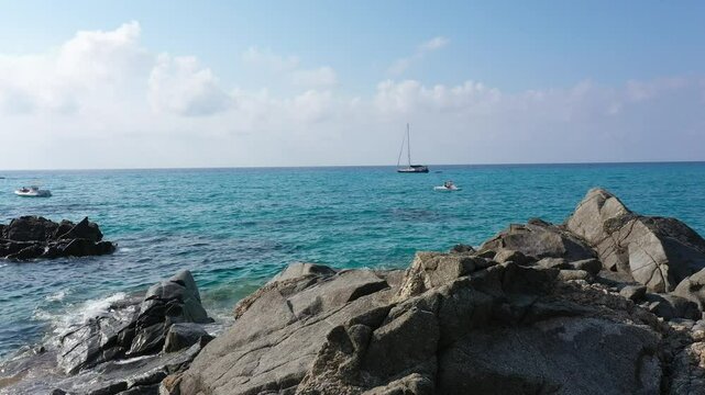 Aerial view of sea and rocky beach in Marinella Di Zambrone on a sunny summer day in Calabria, Italy