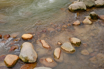 Rust colored rocks in the river