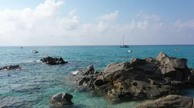 Aerial view of sea and rocky beach in Marinella Di Zambrone on a sunny summer day in Calabria, Italy