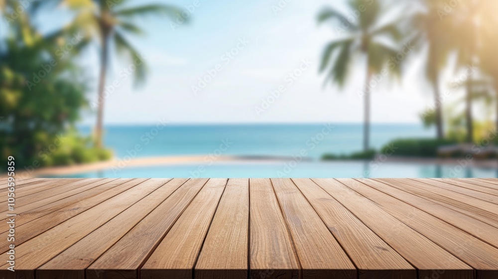 Poster empty wooden tabletop with a blurred background featuring a tropical pool palm trees and ocean ideal