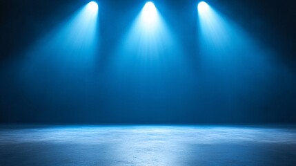 A dark stage illuminated by three powerful blue spotlights, creating a dramatic and moody atmosphere perfect for performances.