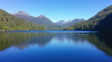 Naklejka premium Serene Lake Surrounded by Majestic Mountains