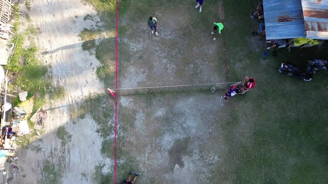 Aerial view of group of young men are playing takraw in the afternoon
