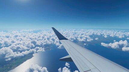 Obraz premium Plane Wing With Blue Sky Mainland And Clouds In The Background