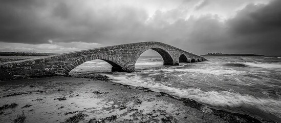 Fototapeta premium Bridge Over The Sea During Ebb Tide In Black And White