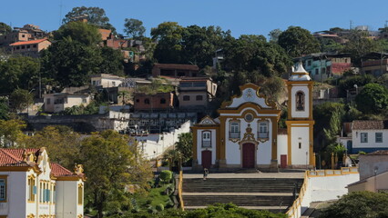 Colonial Church Facade Against a Hillside of Colorful Houses