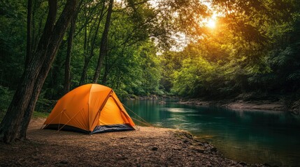 A vibrant orange tent is set up near a tranquil river encircled by verdant trees and illuminated by the warm light of sunset