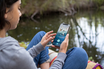 Young individual practicing mindfulness with a meditation app