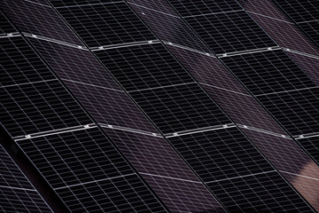 Abstract close-up of solar panels arranged in a diagonal pattern, showcasing clean energy...