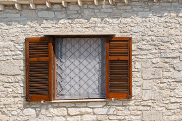 Wooden Shuttered Window on Stone Wall