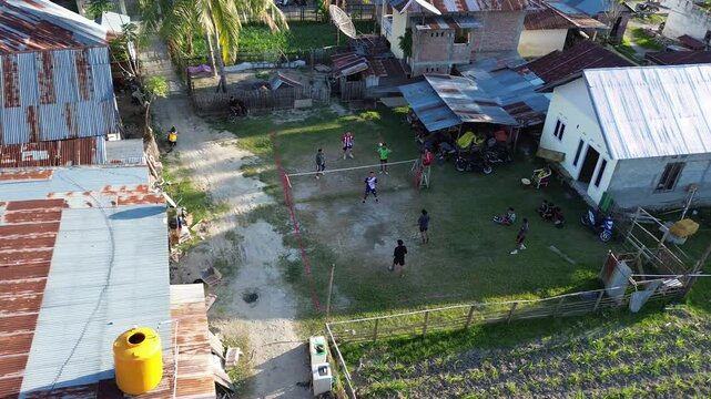 Aerial view of group of young men are playing takraw in the afternoon