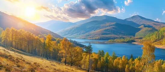 Fototapeta premium Lake High In The Mountains Yellow Deciduous And Green Conifers Sunset And Blue Sky Wonderful Autumn Landscape