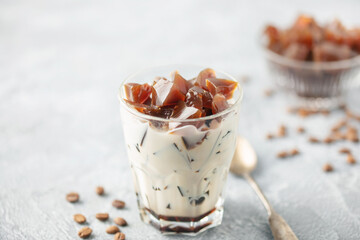 Coffee jelly with milk in glass.