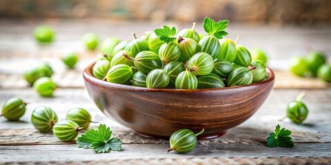 A Wooden Bowl Filled with Freshly Picked Green Gooseberries, Scattered on a Rustic Wooden Surface