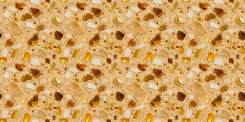 Fototapeta premium A terrazzo surface with shades of citrine yellow, amber, and pale ivory fragments on a warm, light amber background