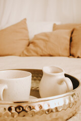 tray with dishes on the bed