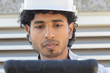 young technician with tablet controlling outside