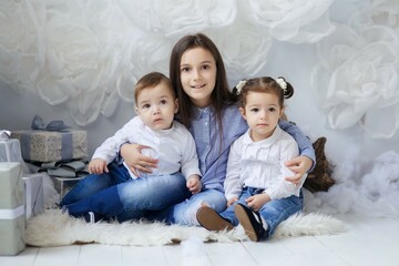 Beautiful children sitting in a room decorated for the new year