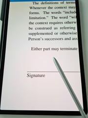Document signing process captured on a digital device, highlighting a signature line and key legal...