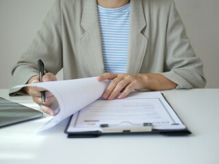 Businesswoman employer holding resume of job applicant to analyze data before job interview, recruit new employee, about recruitment